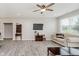 Spacious living room with a ceiling fan, neutral paint, and wood-look laminate flooring at 6644 Aberdeen Dr, McCordsville, IN 46055