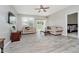 Bright living room features modern ceiling fan, neutral paint, and sliding door access to the backyard at 6644 Aberdeen Dr, McCordsville, IN 46055