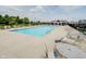 Community pool with lounge chairs, umbrellas, tables, and a nearby clubhouse at 6644 Aberdeen Dr, McCordsville, IN 46055