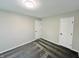 Bedroom showcasing neutral walls, new carpet, overhead lighting, and two doors for easy accessibility throughout the home at 6839 Antelope Dr, Indianapolis, IN 46278