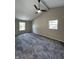 Vaulted ceiling bedroom with carpet, two windows, and a ceiling fan at 6839 Antelope Dr, Indianapolis, IN 46278