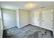 Spacious bedroom with neutral walls, carpet flooring, a window with natural light, and two closets for ample storage at 6839 Antelope Dr, Indianapolis, IN 46278