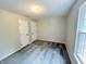 Bedroom featuring neutral walls, plush carpet flooring, a window with natural light, and two doors for easy accessibility at 6839 Antelope Dr, Indianapolis, IN 46278