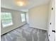 Bright bedroom with neutral walls, two windows that let in ample natural light, and carpet flooring at 6839 Antelope Dr, Indianapolis, IN 46278