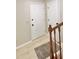 Inviting entryway with staircase featuring wood railing and white doors at 6839 Antelope Dr, Indianapolis, IN 46278