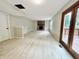 Open living room features a brick fireplace, wood floors, and access to a deck at 6839 Antelope Dr, Indianapolis, IN 46278