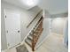 Bright foyer area showcasing staircase with wood railing and access to main floor at 6839 Antelope Dr, Indianapolis, IN 46278
