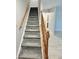Carpeted staircase with wood railing leads to the upper level of the home at 6839 Antelope Dr, Indianapolis, IN 46278