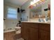 Bathroom with a wood vanity, a large mirror, and natural light, creating a relaxing atmosphere at 7725 S Oak Dr, Indianapolis, IN 46227