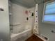 Bathroom featuring a tub with jets and a shower, modern fixtures and ample natural light at 7725 S Oak Dr, Indianapolis, IN 46227