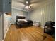 Comfortable bedroom featuring hardwood floors, ceiling fan, and ample natural light at 7725 S Oak Dr, Indianapolis, IN 46227