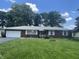 Charming brick home with a well-manicured lawn, attached garage and mature trees in a desirable neighborhood at 7725 S Oak Dr, Indianapolis, IN 46227