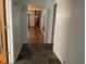 Inviting hallway with tile flooring, neutral paint, and doorway view to a living area at 7725 S Oak Dr, Indianapolis, IN 46227