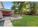Expansive backyard featuring a cozy patio with a covered seating area and outdoor dining space at 8201 Castle Dr, Indianapolis, IN 46256