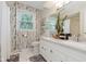 Well-lit bathroom showcasing a double sink vanity, elegant birch-themed wallpaper, and neutral accents at 8201 Castle Dr, Indianapolis, IN 46256