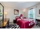 Cozy bedroom featuring a vibrant zebra rug, and a stylish red and white floral comforter at 8201 Castle Dr, Indianapolis, IN 46256