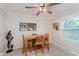 Bright dining room featuring a wooden table, chairs, modern decor, and ample natural light at 8201 Castle Dr, Indianapolis, IN 46256