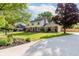 Beautiful home with a long driveway, lush lawn, and mature trees in a serene setting at 8201 Castle Dr, Indianapolis, IN 46256