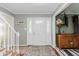 Bright foyer with a decorative rug, stylish lighting, and a welcoming front door at 8201 Castle Dr, Indianapolis, IN 46256