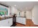 Bright kitchen boasts a center island, granite countertops, and hardwood floors at 8201 Castle Dr, Indianapolis, IN 46256