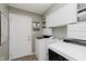 Functional laundry room with white cabinets, modern washer and dryer, and convenient storage at 8201 Castle Dr, Indianapolis, IN 46256