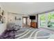 Bright living room with an accent chair, decorative decor, and large windows at 8201 Castle Dr, Indianapolis, IN 46256