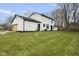 An expansive backyard and exterior showcasing the white siding and attached garage at 8315 N Payne Rd, Indianapolis, IN 46268