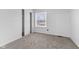 Bright bedroom with a neutral color palette, plush carpeting, and natural light from a window at 8315 N Payne Rd, Indianapolis, IN 46268