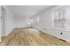 A well-lit living room features new floors and double doors to the backyard and natural light at 8315 N Payne Rd, Indianapolis, IN 46268