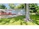 Photo of the backyard with a small deck on the back of the home and mature trees at 8336 S Belmont Ave, Indianapolis, IN 46217