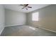 A bright bedroom showcases plush carpeting, ceiling fan and a window for natural light at 8336 S Belmont Ave, Indianapolis, IN 46217
