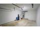 Garage interior featuring concrete floors, garage door, water heater and water softener at 8336 S Belmont Ave, Indianapolis, IN 46217