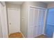 Hallway features wood look flooring, and several white doors at 8336 S Belmont Ave, Indianapolis, IN 46217