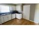 Well-lit kitchen features stainless sink, microwave, dishwasher, and abundant cabinet storage at 8336 S Belmont Ave, Indianapolis, IN 46217