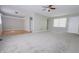Spacious living room with neutral carpet, ceiling fan, and natural light, great for entertaining at 8336 S Belmont Ave, Indianapolis, IN 46217