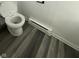 Close-up of a white toilet and heater in a simple, well-maintained bathroom at 8434 Meadowlark Dr, Indianapolis, IN 46226
