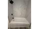 Modern bathroom with black hardware and fixtures with a marble-look shower wall at 8434 Meadowlark Dr, Indianapolis, IN 46226