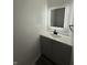 Modern bathroom featuring a vanity with a lighted mirror, cabinet storage, and neutral walls at 8434 Meadowlark Dr, Indianapolis, IN 46226