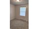 Neutral bedroom with light-colored carpet, natural light from the window, and textured ceiling at 8434 Meadowlark Dr, Indianapolis, IN 46226