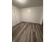 Cozy bedroom features wood laminate flooring, fresh white walls, and neutral trim at 8434 Meadowlark Dr, Indianapolis, IN 46226