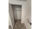 A glimpse into the closet with neutral colored carpet and white shelving at 8434 Meadowlark Dr, Indianapolis, IN 46226