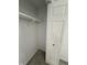 Bedroom closet with carpet flooring, white walls, shelving and white paneled door at 8434 Meadowlark Dr, Indianapolis, IN 46226