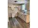 Well-lit kitchen with white cabinets, granite countertops, stainless steel faucet, and wood flooring at 8434 Meadowlark Dr, Indianapolis, IN 46226