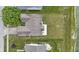 Aerial view showcasing the roof and backyard with patio, next to the pond at 8778 N Deer Crossing Blvd, McCordsville, IN 46055