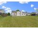 Exterior view of a home with a large, well-maintained lawn and an open backyard space at 8778 N Deer Crossing Blvd, McCordsville, IN 46055