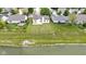 Aerial view of a well-maintained backyard with lush green grass and a view of the tranquil lake at 8778 N Deer Crossing Blvd, McCordsville, IN 46055