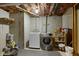 Practical basement laundry area with washer, dryer, and ample storage space at 8778 N Deer Crossing Blvd, McCordsville, IN 46055