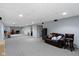 Wide basement with neutral carpet, recessed lights, and a casual seating area with a brown couch at 8778 N Deer Crossing Blvd, McCordsville, IN 46055