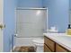 Bathroom with bright blue walls, a shower and tub combo, toilet, and vanity at 8778 N Deer Crossing Blvd, McCordsville, IN 46055