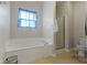 Bathroom features a soaking tub, glass enclosed shower and toilet at 8778 N Deer Crossing Blvd, McCordsville, IN 46055